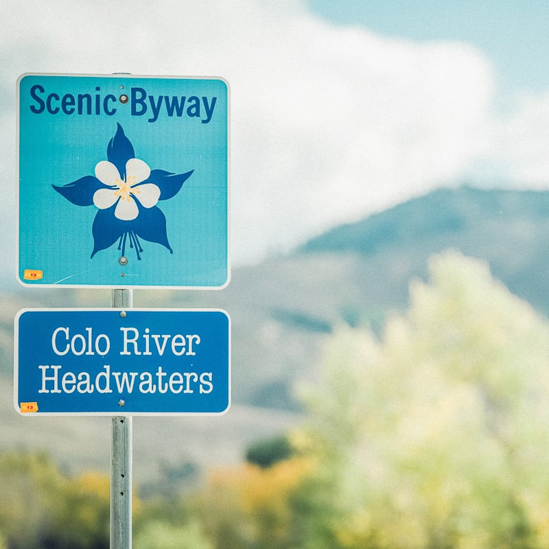 A sign that says scenic byway columbia river headwaters.