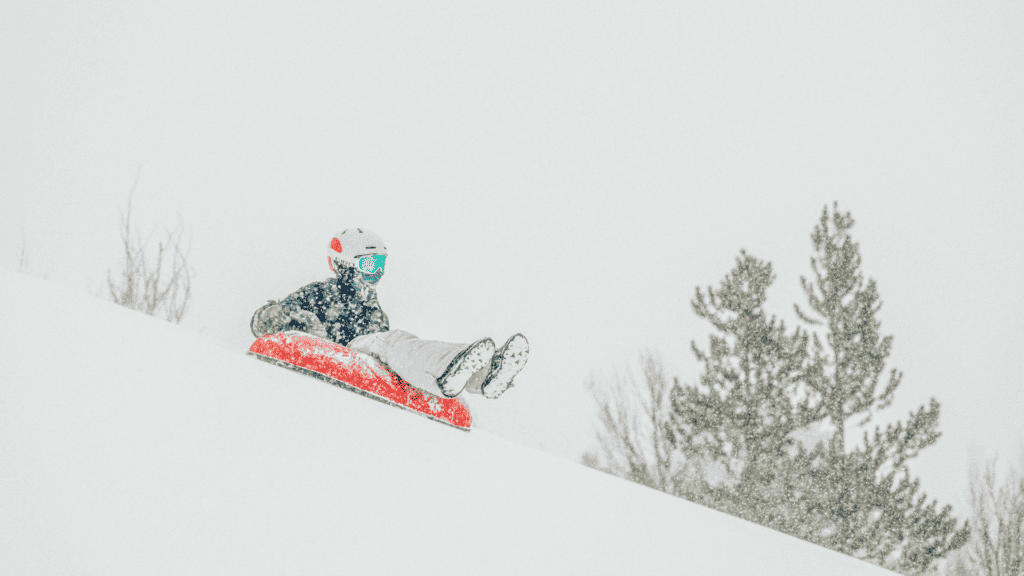 A person sledding down a snowy hill.