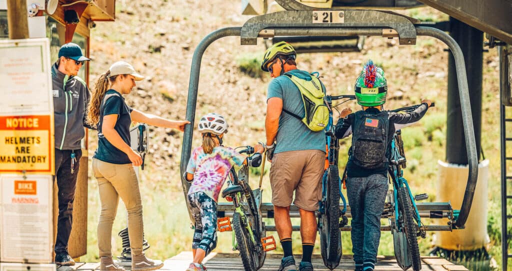Family biking at Winter Park Resort during summer—one of the top family-friendly activities in Grand County, Colorado.