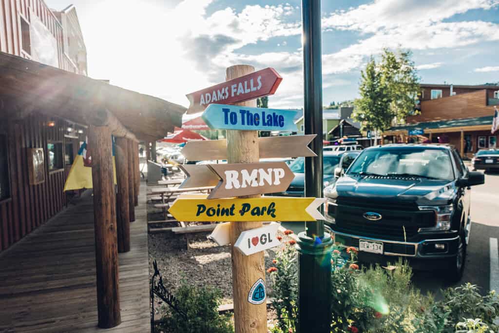 A wooden pole with directional signs.