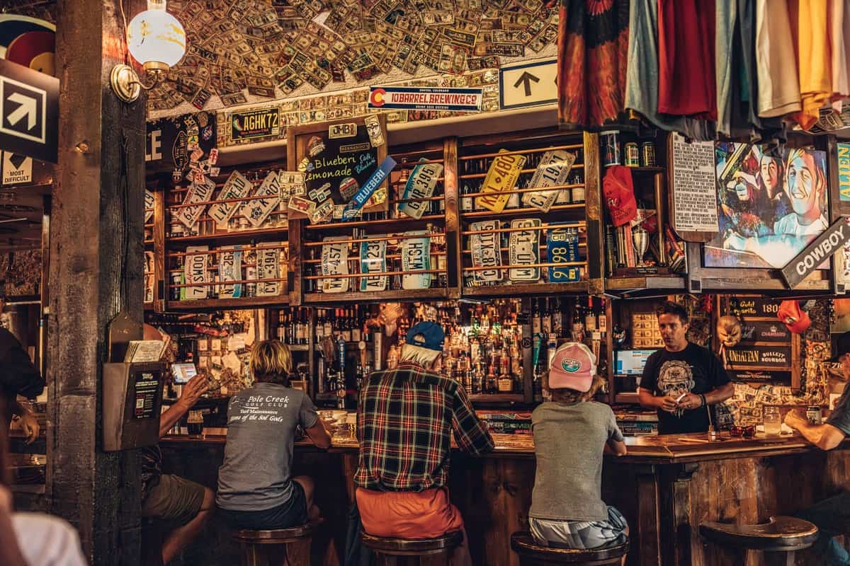 A group of people sitting at the bar at Hernandos Pizza and Pasta Pub restaurant in Winter Park.