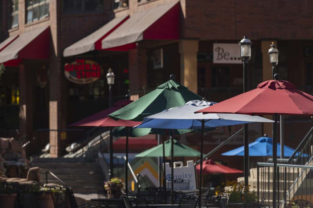 A row of restaurant umbrellas on a sidewalk in Winter Park, Colorado.