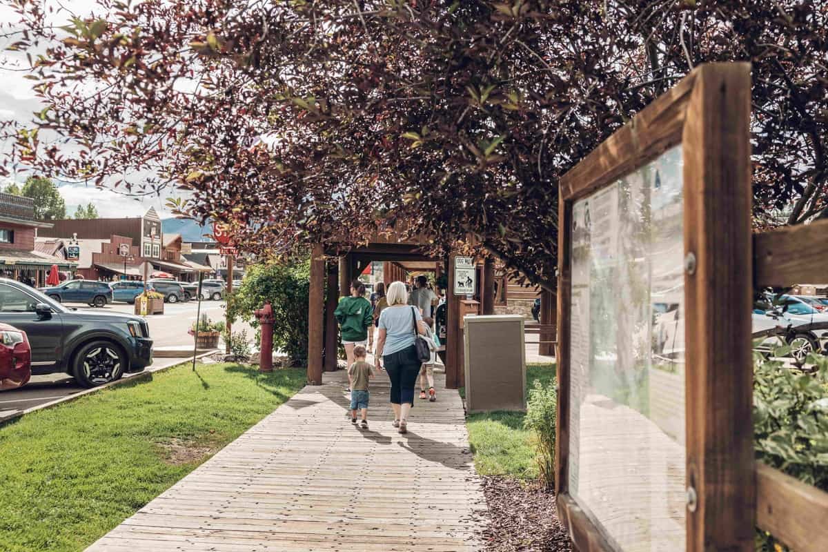 A group of people walking in downtown Grand Lake.