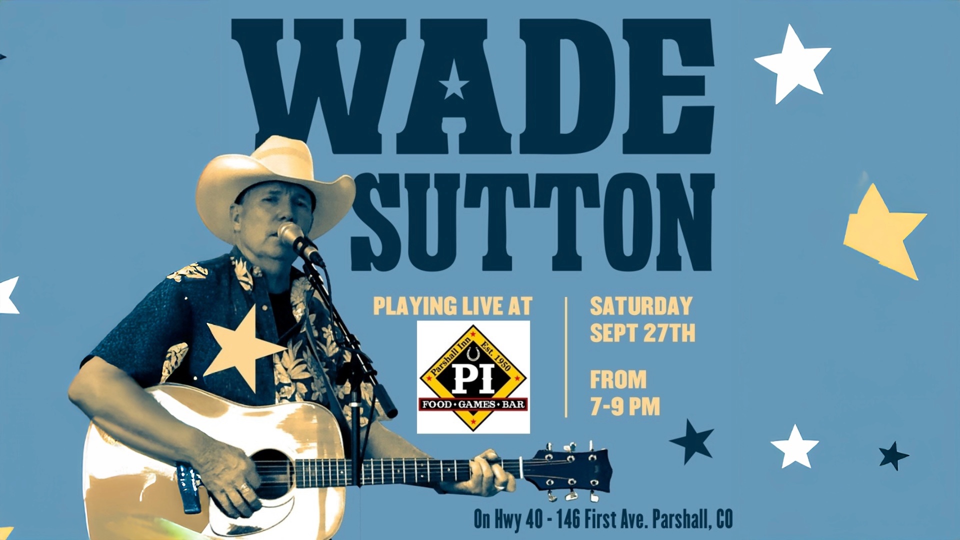 A man in a cowboy hat plays an acoustic guitar and sings into a microphone in Grand County Colorado.