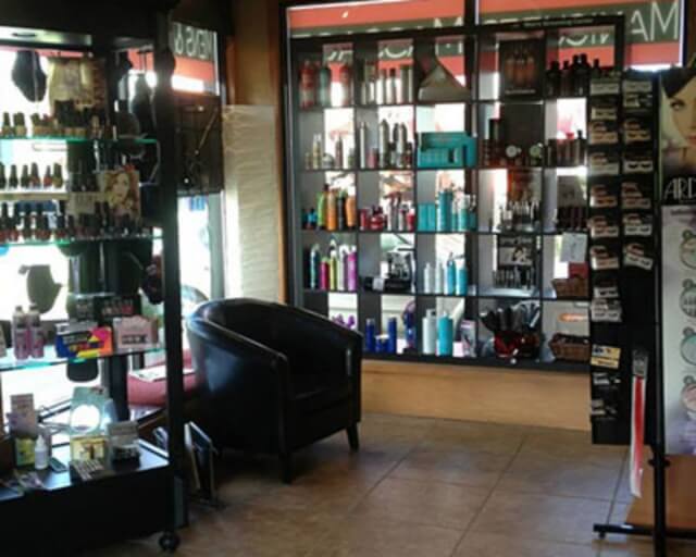 A beauty supply store with shelves of hair and nail products and a black chair in Grand County Colorado.