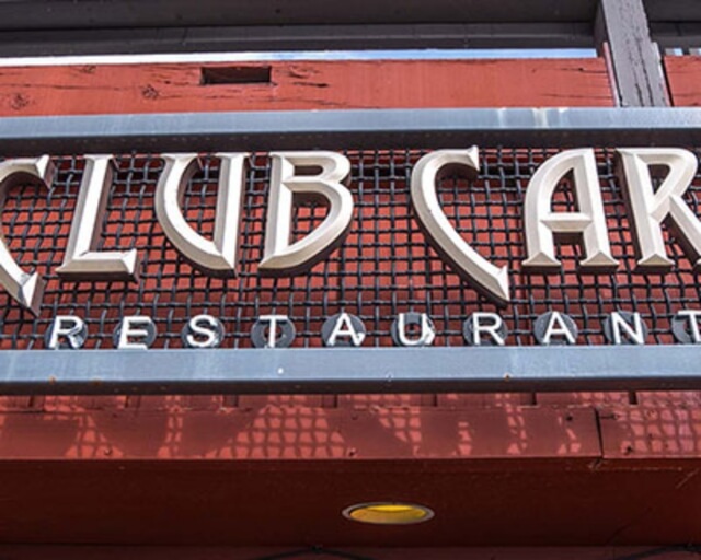 Sign for Club Car Restaurant with metal lettering on red background in Grand County Colorado.