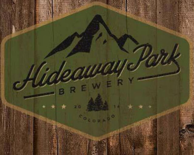 A green hexagonal sign with a mountain and tree design for Hideaway Park Brewery in Grand County Colorado.