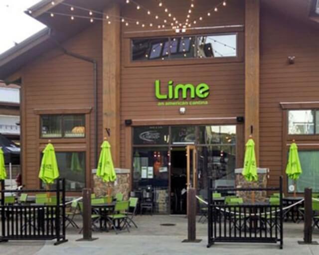 A vibrant restaurant named Lime with green umbrellas and outdoor seating in Grand County Colorado.
