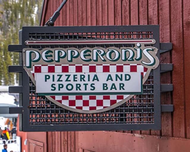 Sign for Pepperoni's Pizzeria and Sports Bar with checkered pattern and red background in Grand County Colorado.