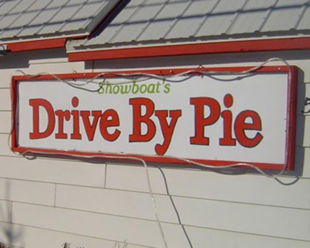 A sign for Showboat's Drive By Pie, featuring red text on a white background in Grand County Colorado.