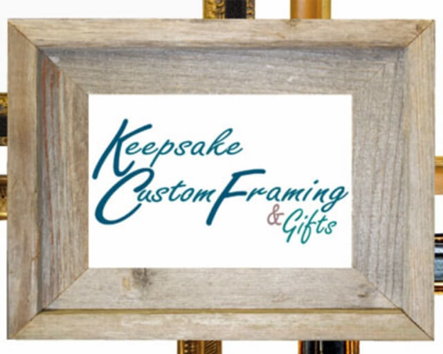 A rustic wooden picture frame displays the text 'Keepsake Custom Framing & Gifts' in elegant script in Grand County Colorado.