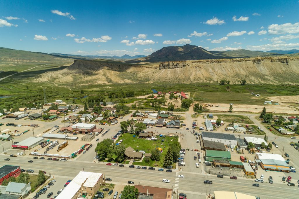 Aerial view of downtown Kremmling with surrounding valley and mountains.