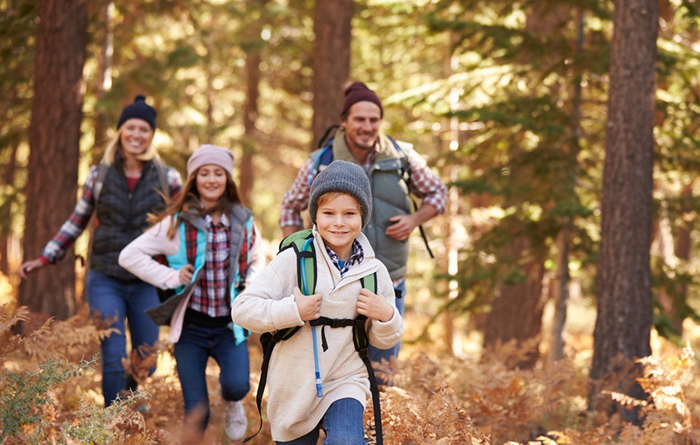 Family hiking on a forest trail in Grand County, Colorado.