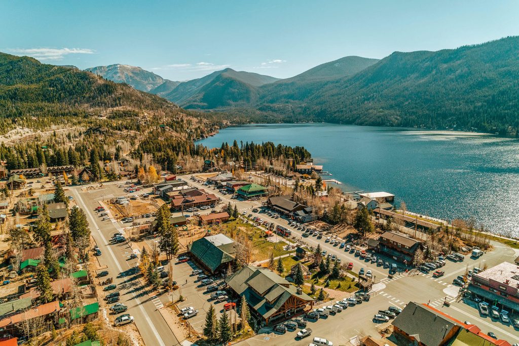 Aerial view of a mountain lake village with colorful buildings and a bustling main street in Grand County Colorado.