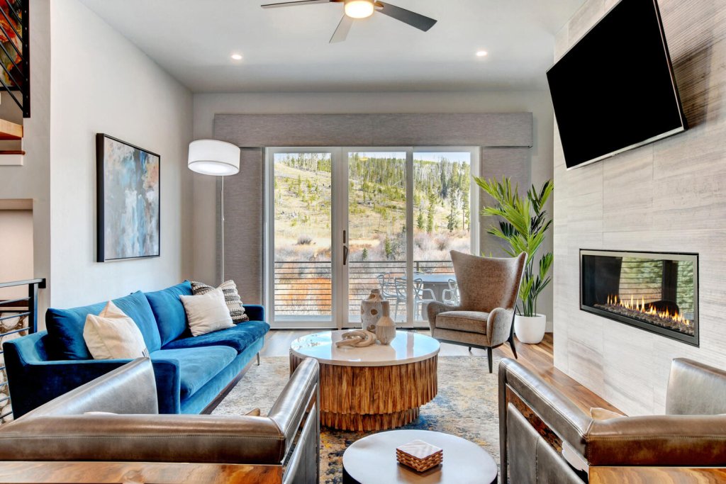 A stylish living room with a fireplace, comfortable seating, and a modern aesthetic in Grand County Colorado.