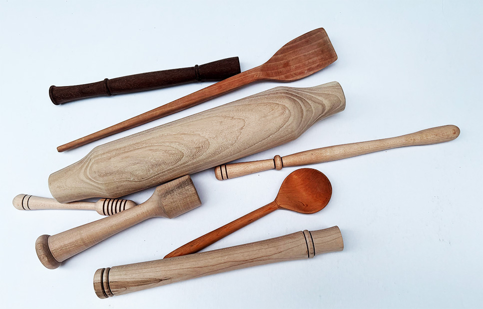 A collection of wooden kitchen utensils, including rolling pins and spoons in Grand County Colorado.