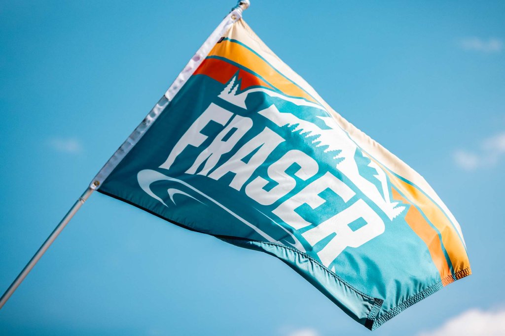 A colorful flag with the word Fraser and an illustration of a mountain unfurling in the breeze.