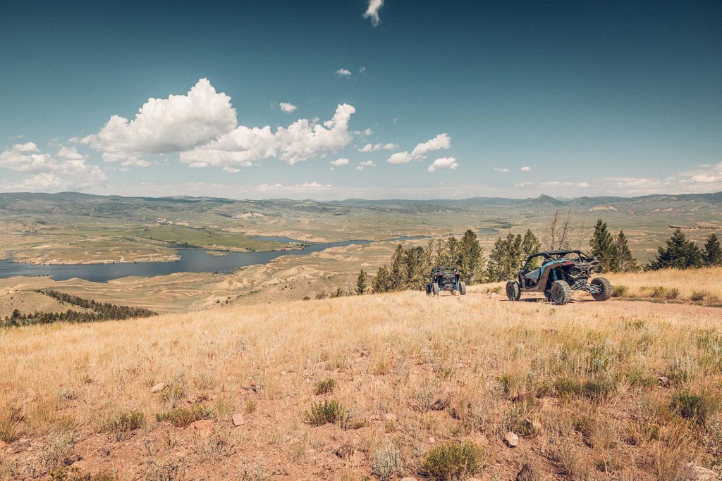 ATV riders exploring a rugged mountain trail with sweeping views of the Kremmling, Colorado landscape.